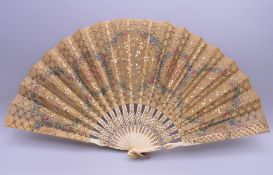 A Victorian golden silk sequin fan with decorated sticks and guards. 21.