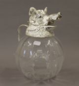 A silver plated boars head glass jug. 26 cm high.