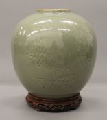 A Chinese celadon vase on stand. 25 cm high overall.