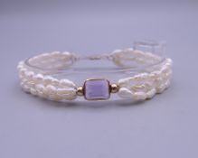 A 14 ct gold amethyst and pearl bracelet. 18 cm long.