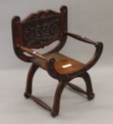 A Victorian walnut carved open armchair. 60 cm wide.