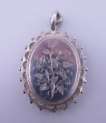 A silver locket. 4.5 cm high.