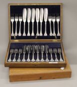 Two canteens of silver plated cutlery.