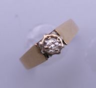 A 9 ct gold diamond solitaire ring. Ring size M/N. 2.8 grammes total weight.