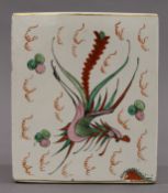 A Chinese porcelain flower brick decorated with a dragon and phoenix. 15 cm high.
