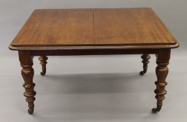 An early 19th century mahogany extending dining table, with additional leaves.
