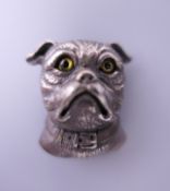 A silver brooch formed as a dog. 3 cm high.