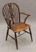 An elm seated Windsor chair. 53 cm wide.
