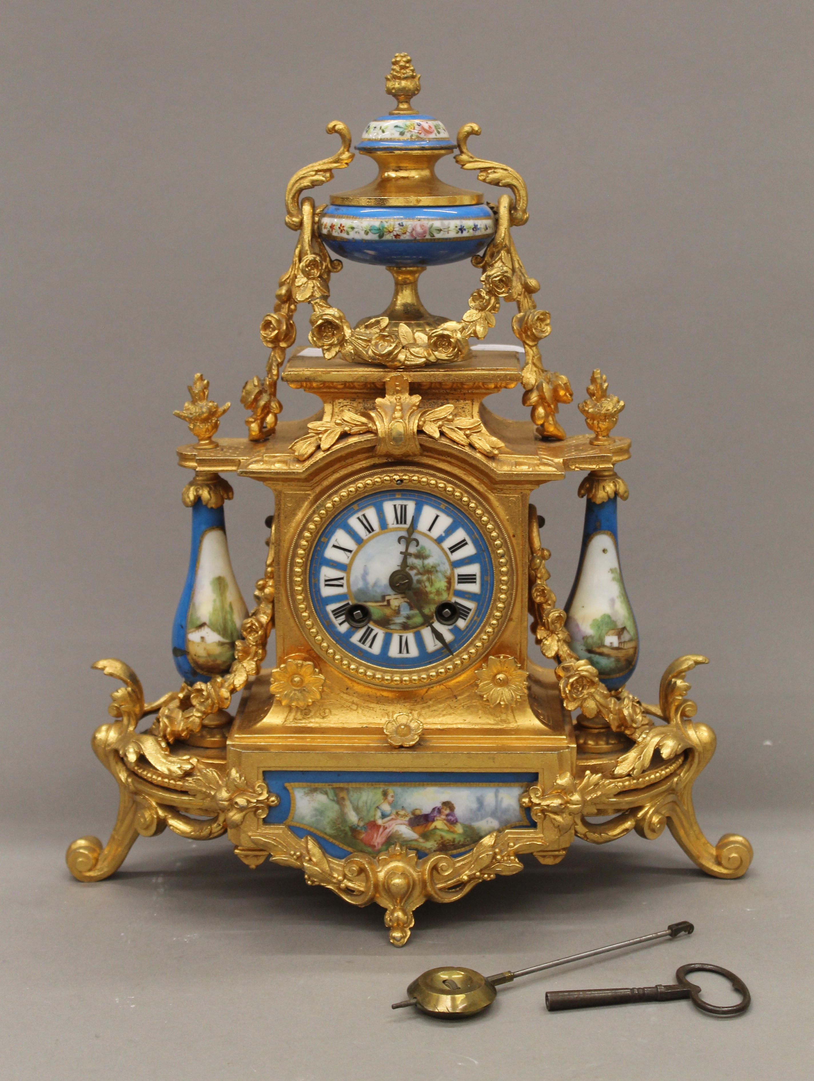 A 19th century gilt and painted porcelain three-piece clock garniture. The clock 37 cm high. - Image 2 of 11