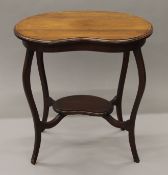 An Edwardian mahogany kidney shaped side table. 66 cm wide.