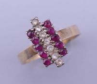 An 18 K gold ruby and diamond ring. Ring size L/M. 2.1 grammes total weight.