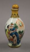 A Chinese porcelain snuff bottle decorated with an erotic scene. 9.5 cm high.