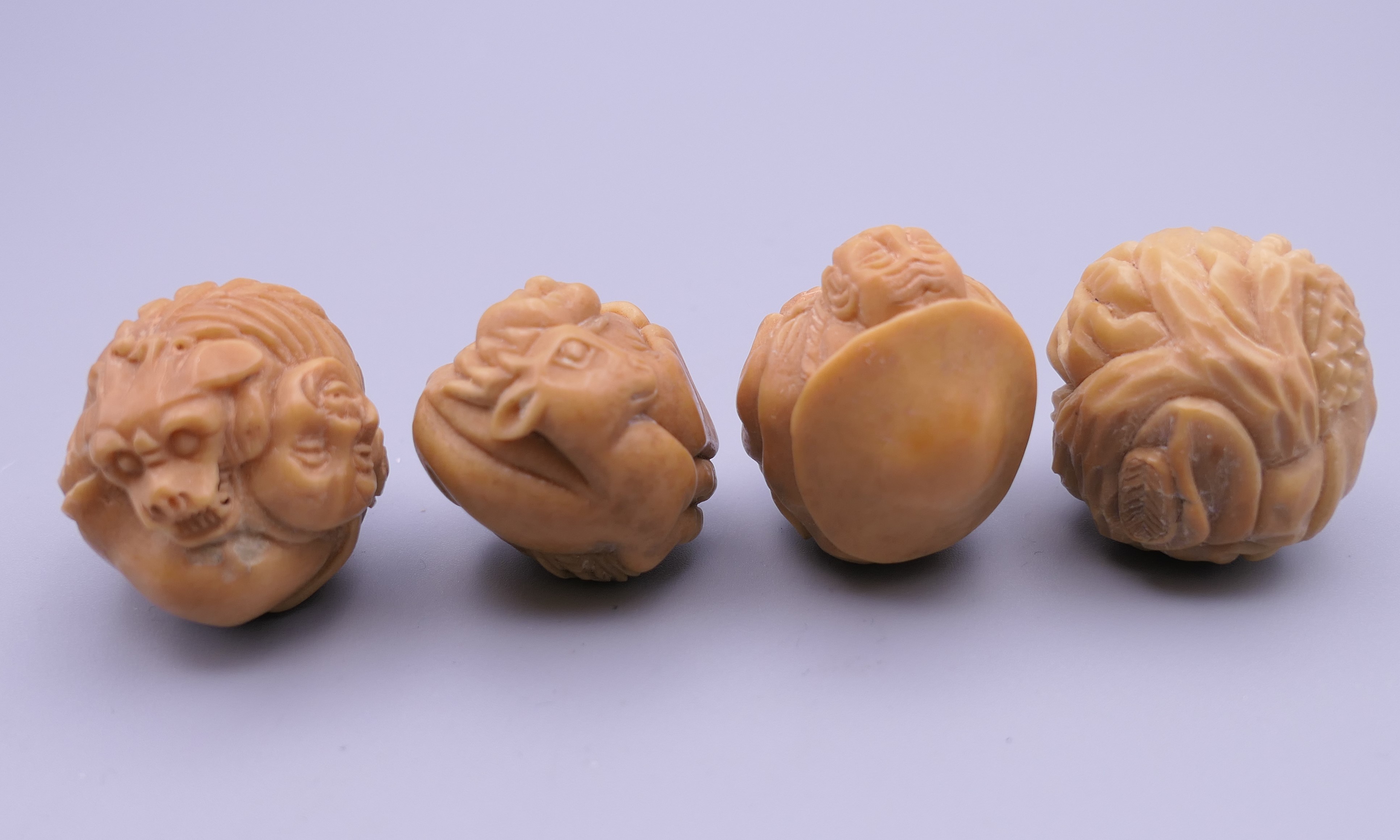 Four carved bone netsuke. Each approximately 3 cm wide. - Image 4 of 4