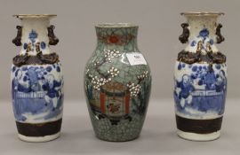 A pair of 19th century Chinese blue and white crackleware vases and a celadon ground crackleware