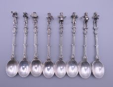 A set of eight Continental white metal teaspoons, each finial formed as a musician. Each 12 cm high.