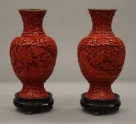 A pair of Chinese cinnabar lacquer vases on stands. 18 cm high overall.