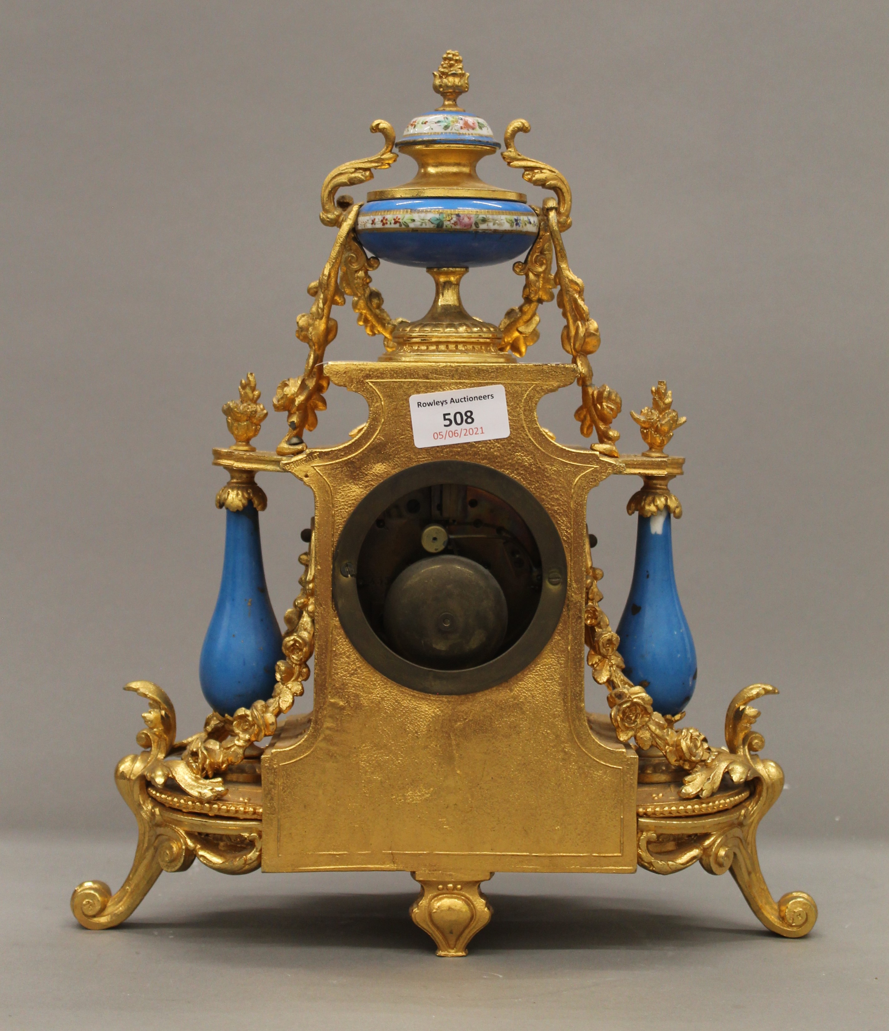 A 19th century gilt and painted porcelain three-piece clock garniture. The clock 37 cm high. - Image 7 of 11