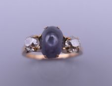 An 18 ct gold diamond and star sapphire ring. Ring size D/E.