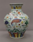 A Chinese porcelain vase decorated with fish. 32 cm high.