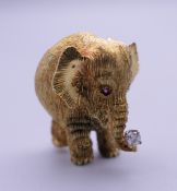 A 14 ct gold diamond and ruby elephant formed brooch. 2.5 cm high. 11.6 grammes total weight.