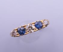 An 18 ct gold diamond and sapphire ring. Ring size P/Q. 2.3 grammes total weight.