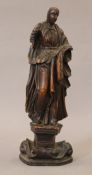 An early wood carving of a figure. 29 cm high.