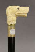 A walking stick with a carved bone handle formed as a dog. 92.5 cm long.