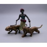A cold painted bronze model of an Arab and tigers. 7 cm high.