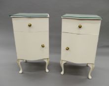 A pair of white painted pot cupboards. 66 cm high.