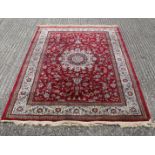 A red ground full pile Kashmir rug. 230 x 155 cm.
