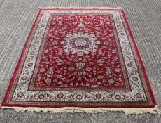 A red ground full pile Kashmir rug. 230 x 155 cm.