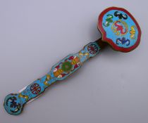 A Chinese enamel decorated bronze ruyi sceptre. 20 cm long.