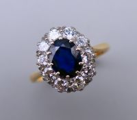 An 18 ct gold and platinum oval sapphire and diamond ring. Diamond approximately 1 carat.