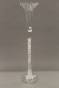 A large clear glass flute. 76 cm high.