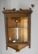 A 19th century carved oak hanging corner cabinet. 60 cm wide.