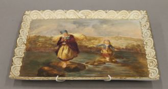 A Victorian porcelain tray, painted with figures crossing a river. 28.5 cm wide.