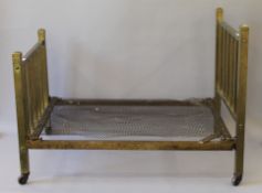 A small Victorian brass framed bed. 75.5 cm long x 45.5 cm wide.