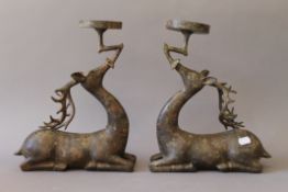 A pair of Chinese bronze deer form candle holders. 33 cm high.