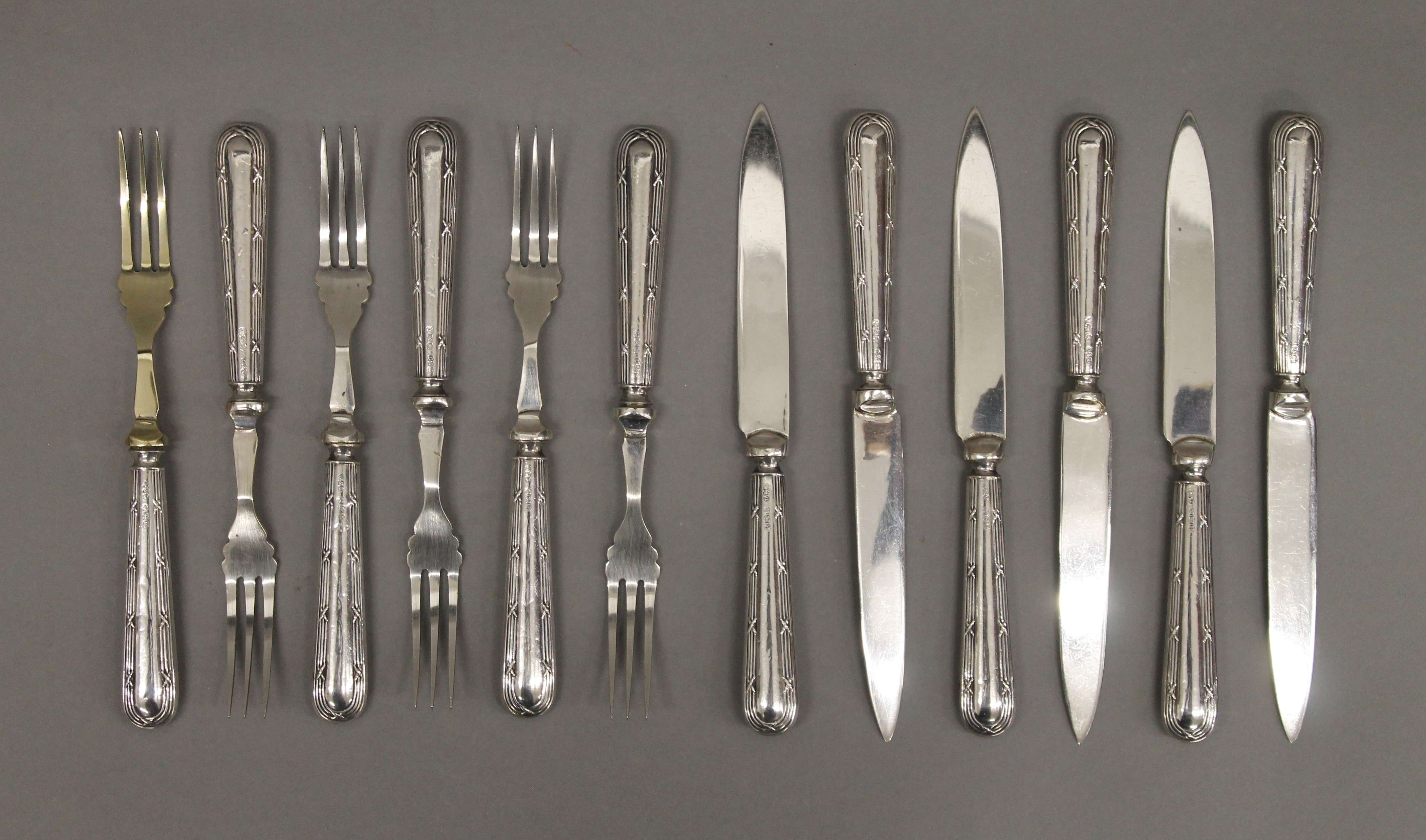 A set of twelve 925 silver handled dessert knives and forks.