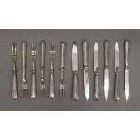 A set of twelve 925 silver handled dessert knives and forks.