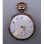 A silver pocket watch. 5 cm diameter.