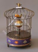 A cloisonne birdcage clock. 21 cm high.