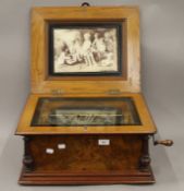 A 19th century inlaid walnut cased polyphon musical box, together with a small quantity of discs.