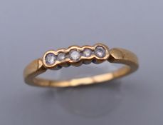 A 9 ct gold five stone diamond ring. Ring size M/N. 1.9 grammes total weight.