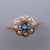 A 9 ct gold aquamarine and pearl ring. Ring size M/N.