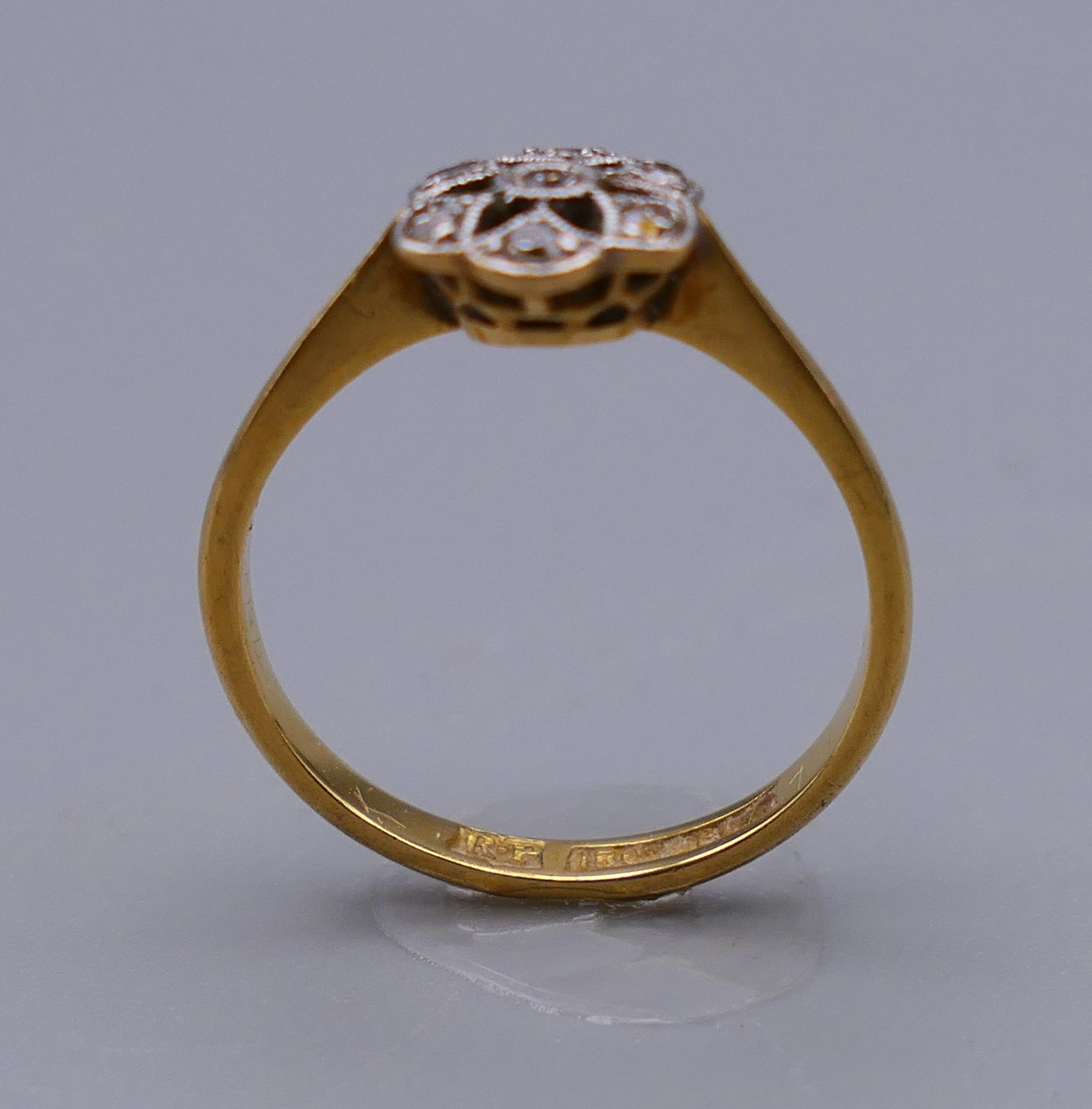 An 18 ct gold and diamond flower head ring. Ring size M. 8 mm high. - Image 4 of 8