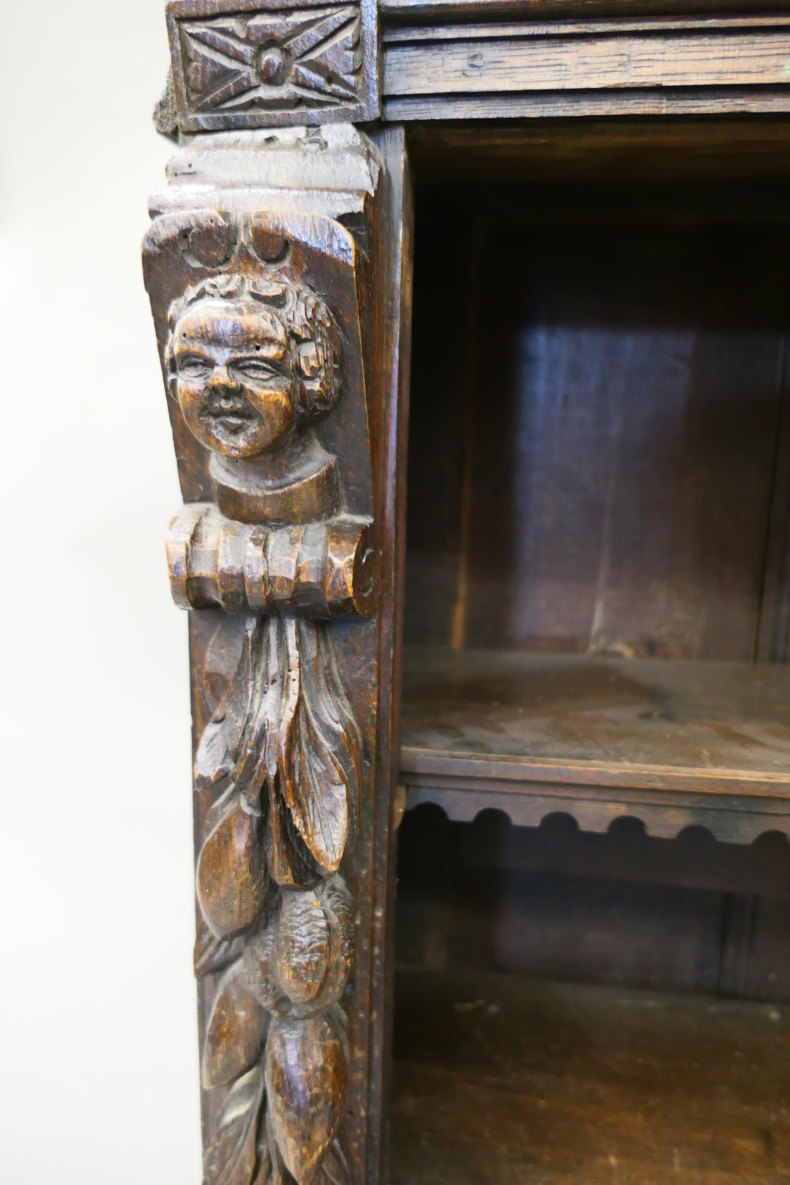 A 19th century oak bookcase carved with figures and foliage. 69.5 cm wide. - Image 4 of 13