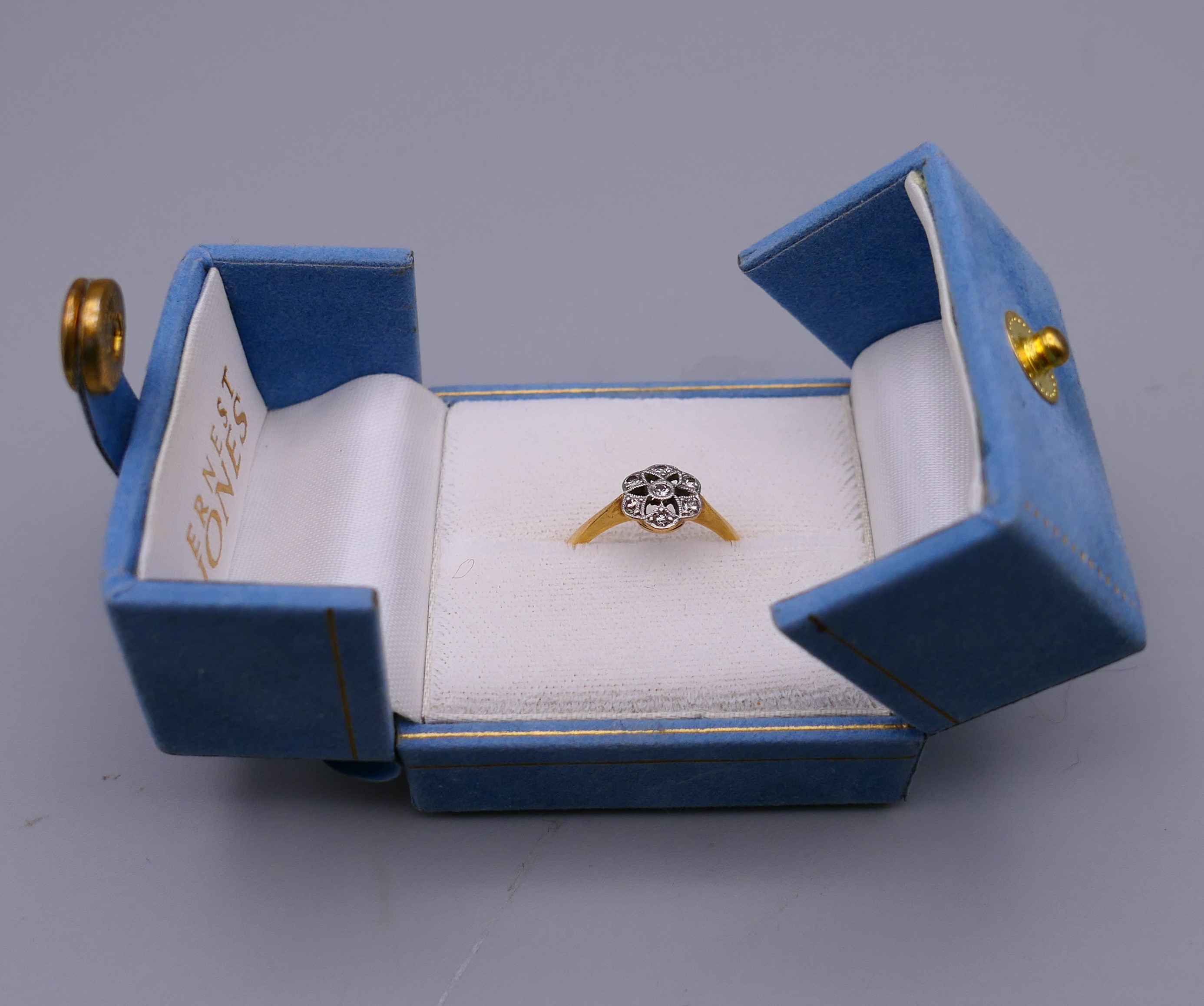 An 18 ct gold and diamond flower head ring. Ring size M. 8 mm high. - Image 8 of 8