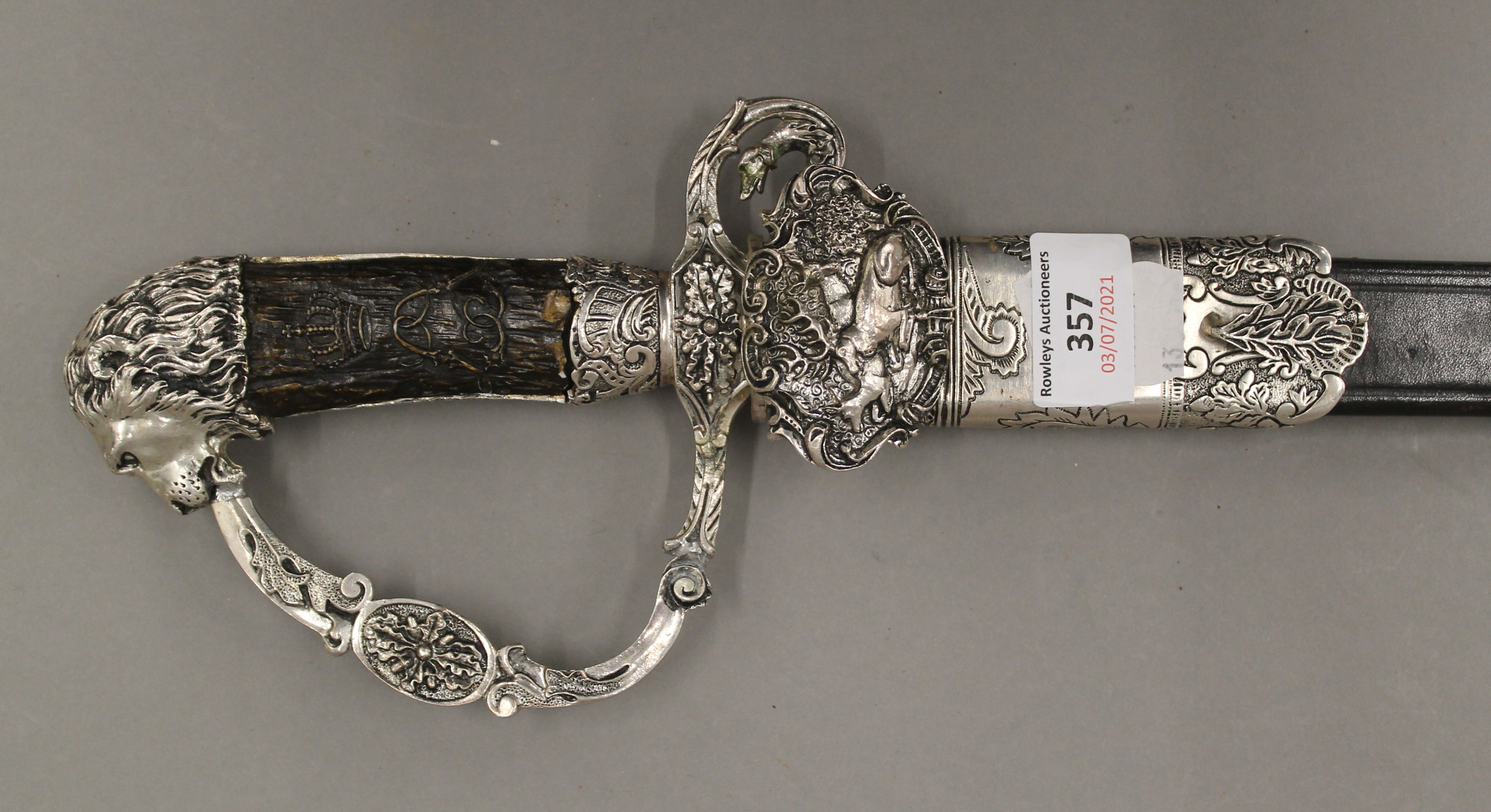 A hunting hanger, the scabbard and handle with silvered mounts. 80 cm long.