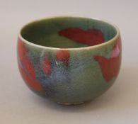 A Chinese red splash celadon bowl. 13 cm diameter.